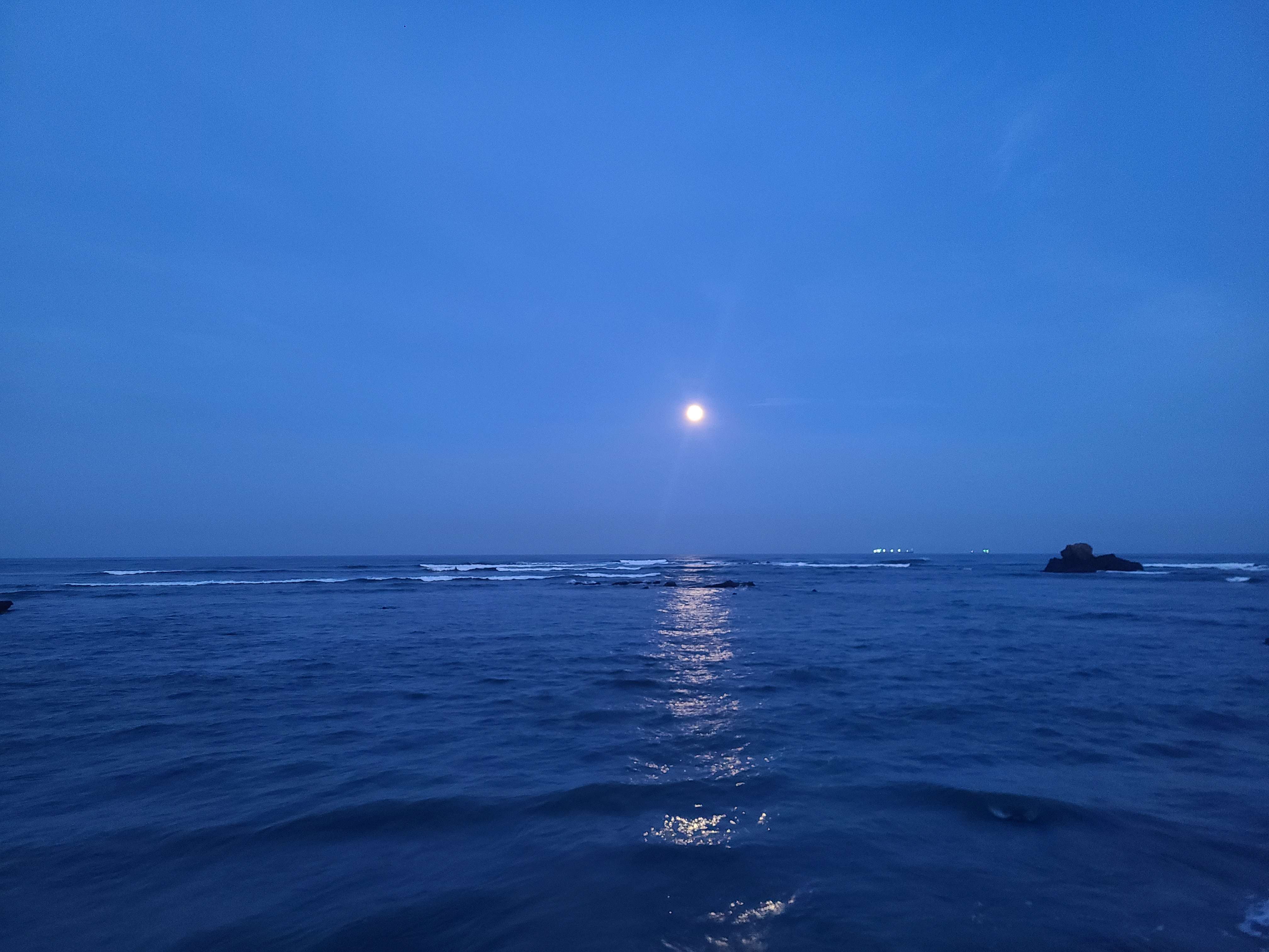 moon setting over the ocean